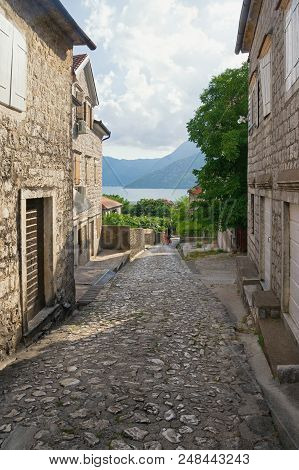 Narrow Picturesque Street Descends To The Sea. Montenegro, Bay Of Kotor, Town Of Risan, Gabela Stree