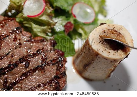 Grilled Beef Steak And Bone Marrow With Salad, Close Up