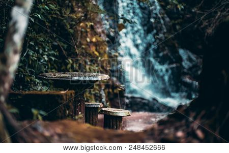 Magical Dark Forsaken Place In The Rainforest With Ancient Stone Table And Backless Stools Near It, 
