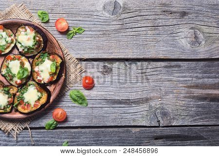 Mini Pizza With Eggplant , Tomato And Basil . Top View With Space For Text