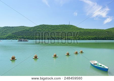 Boat For Skiing And Houses For Wild Ducks On The Green Water Of The Mountain Lake Abrau-durso