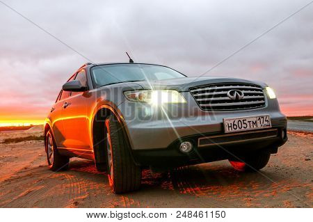 Novyy Urengoy, Russia - July 1, 2018: Grey Crossover Infiniti Fx35 At The Countryside At The Backgro