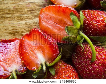 Beautiful  Red Strawberry On A Wooden  Background.