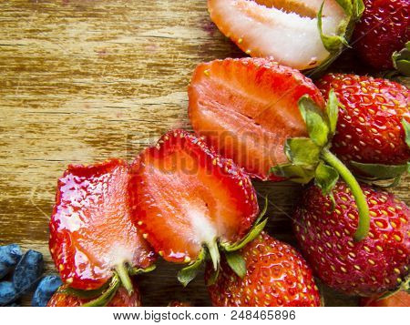 Beautiful  Red Strawberry On A Wooden  Background.