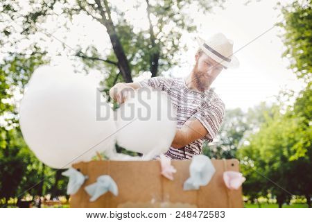 Photo Theme Small Business Cooking Sweets. A Young Man With A Beard Of A Caucasian Trader In The Hat