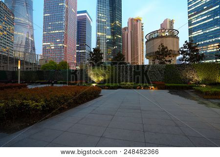 Empty Marble Road Surface With City Buildings Of Night