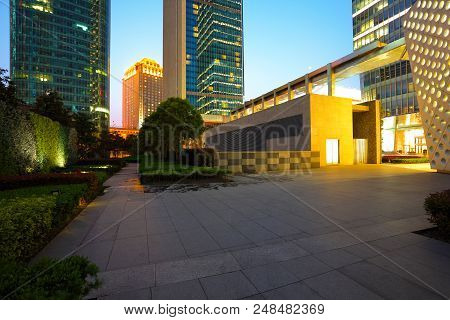 Empty Marble Road Surface With City Buildings Of Night