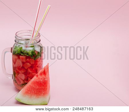 Watermelon Smoothie With Slice Of Fruit And Leaf Of Mint Over Pink Background, Copy Space, Close Up.