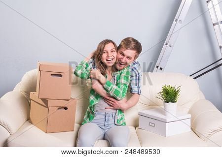 Young Cheerful Couple Moving Into Their New Home.