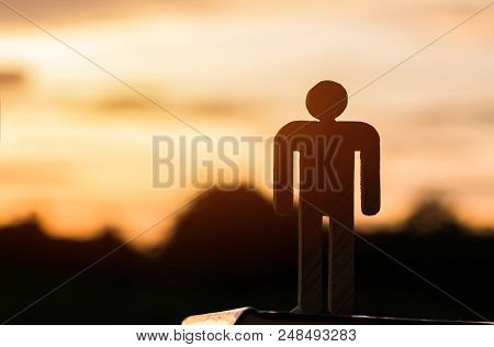Silhouette Of Sign Man Wood Standing On Textbook At Twilight Sky Sunset Evening Background, Active L
