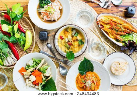 Table Top View Thai Traditional Cuisine. Pad Pak Ruam Mitr Stir Vegetables. Red Curry Chicken Coconu