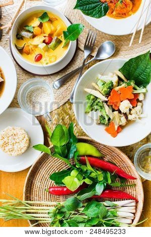Thai Traditional Cuisine Table. Pad Pak Ruam Mitr Stir Vegetables, Red Curry Chicken In Coconut Milk