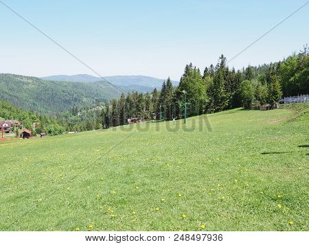 Amazing Landscapes Of Grassy Field And Forest At Beskid Mountains Range In European Salmopol Pass At