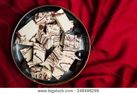 Halva With Cacao Pieces On A Plate Top View