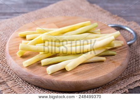 Fresh Raw Green Beans On A Cutting Board On A Wooden Table