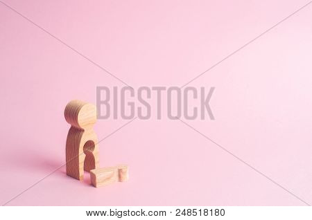 A wooden figure of a woman with a void from which a child fell. The concept of the loss of a child, abortion of pregnancy, miscarriage. mother lost her child. Deprivation of parental rights.