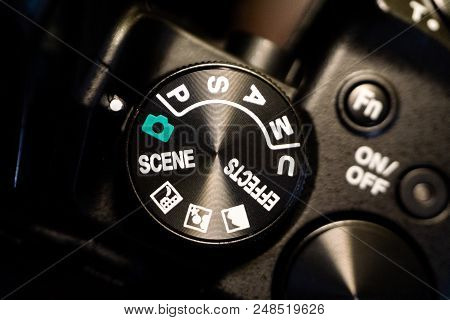 Close-up Macro Shot Of Black Camera Body With Buttons To Control And Switch Shooting Modes. Selectiv