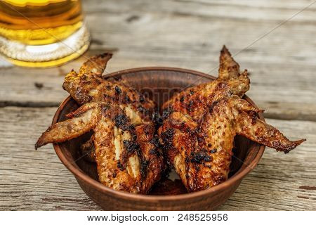 Delicious Grilled Chicken Wings And Beer On A Wooden Table. Pub, Party. Sports Bar.