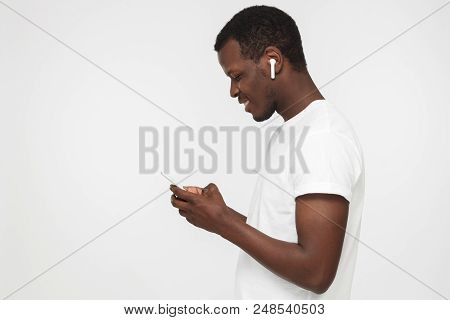 Side Portrait Of Handsome African American Man In Blank White T Shirt, Isolated On Gray Background, 