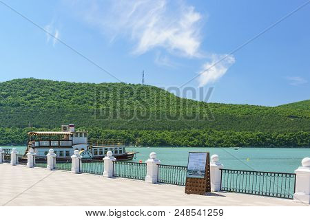 Champagne Pleasure Boat On The Pier Of The Picturesque Mountain Lake Abrau. Pillar With Conditions O