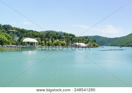 Amphitheatre With Music Stage On The Central Embankment Of Lake Abrau. The Serenity Of A Summer Sunn