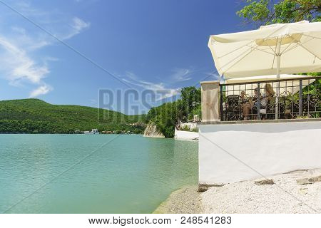 Summer Cafe On The Bank Of The Picturesque Mountain Lake Abrau. Sunny Day