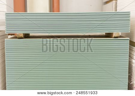 Pallet With Plasterboard In The Building Store. Warehouse With Plasterboard. Sheets Of Plasterboard 