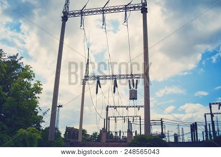 High-voltage Wires On Poles Under High Voltage. Tinted Image. Power Plants On The Industry.