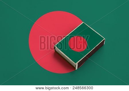 Bangladesh Flag  Is Pictured On A Matchbox That Lies On A Large Flag.