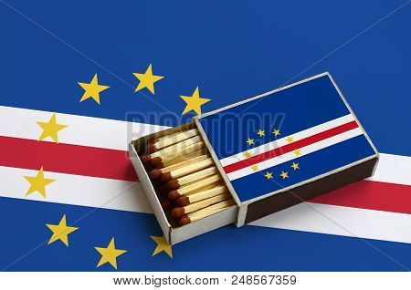 Cabo Verde Flag  Is Shown In An Open Matchbox, Which Is Filled With Matches And Lies On A Large Flag