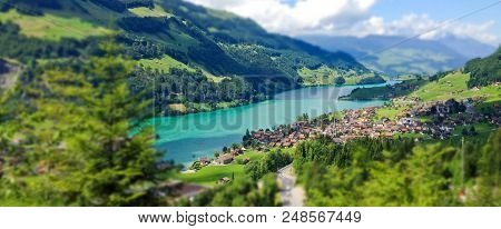 Beautiful Summer Day View From Train Window In Miniature Style Of Lungern Village And Lake Lungern, 