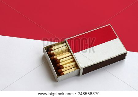 Indonesia Flag  Is Shown In An Open Matchbox, Which Is Filled With Matches And Lies On A Large Flag.
