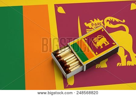 Sri Lanka Flag  Is Shown In An Open Matchbox, Which Is Filled With Matches And Lies On A Large Flag.