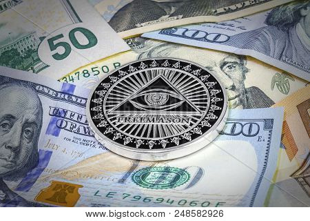 Freemason Symbol Coin On Hundred Dollar Bills. Cryptocurrency Background
