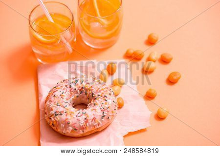 Sprinkled Pink Donut. Frosted Sprinkled Donut On Pink Background.