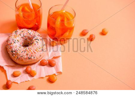 Sprinkled Pink Donut. Frosted Sprinkled Donut On Pink Background.