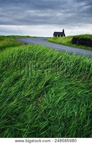 Black wooden church Budakirkja. Famous tourist attractions of Iceland near the village Budhir