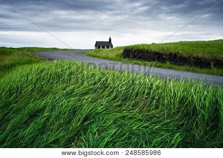 Black wooden church Budakirkja. Famous tourist attractions of Iceland near the village Budhir