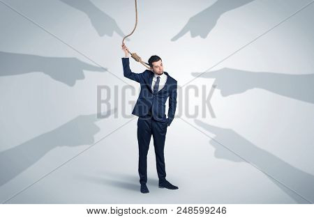 Young businessman trying to suicide with pointing hands concept