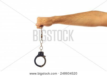 Law Issues. Handcuffs In A Male Hand Isolated On White Background, Clipping Path