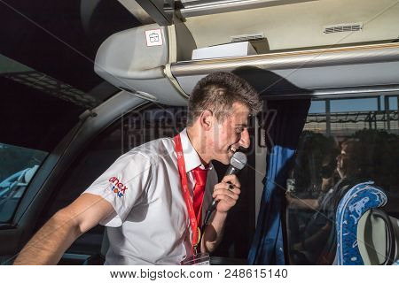 Marmaris, Turkey - May 19, 2018: Male Tour Guide With A Microphone In The Bus In Evening Time