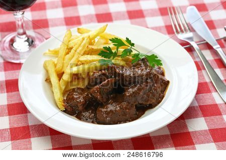 carbonade flamande with frites , flemish beef stew, belgian cuisine