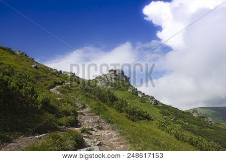 Photo Of Mountain Landscape In The Summer Under Beautiful Cloudy Sky. Ukraine, Carpathians, Dzembron