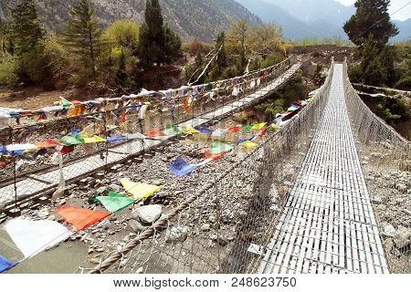 Two Rope Hanging Suspension Bridge In Nepal Himalayas Mountains, Round Annapurna Circuit Treking Tra