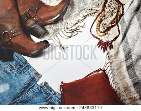 Boho Style. Leather Boots, Denim And Bag With Fringe On White Background. Overhead View Casual Day O
