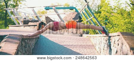 The Girl Is Standing In The Plank.
