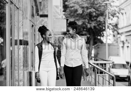 Two Stylish African American Girls Friends Posed Outdoor Of Steets City.