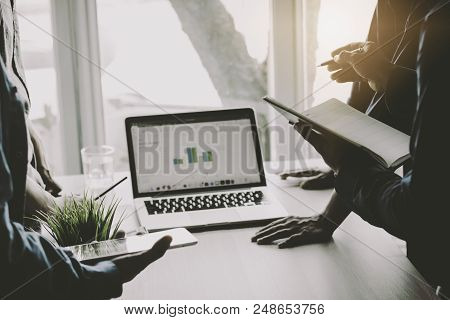 Businessman Meeting, Analyzing And Presenting Finance On Notebook, Teamwork And Coorperation Concept