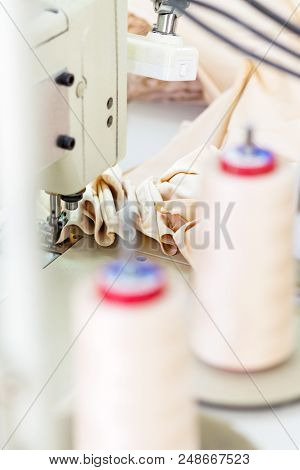 Sewing Machine On The Background Bobin With Threads. The Sewing Process. Background