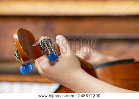 The Boy Plays The Guitar And Takes Chords, Dombra On The Background Of The Piano.